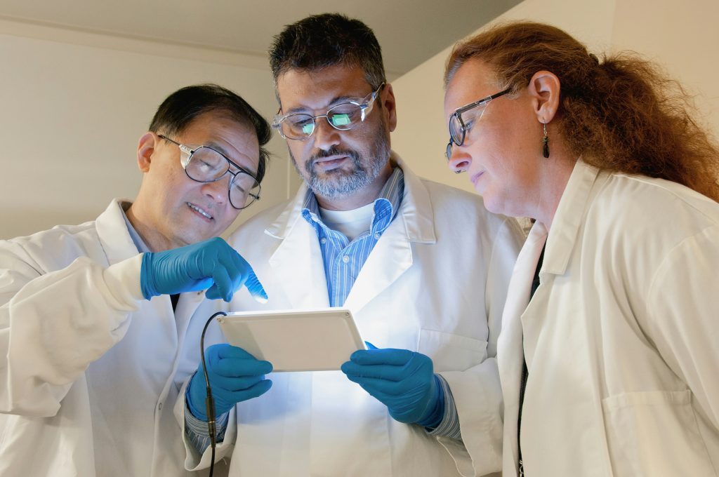 Chemists in the lab with a tablet